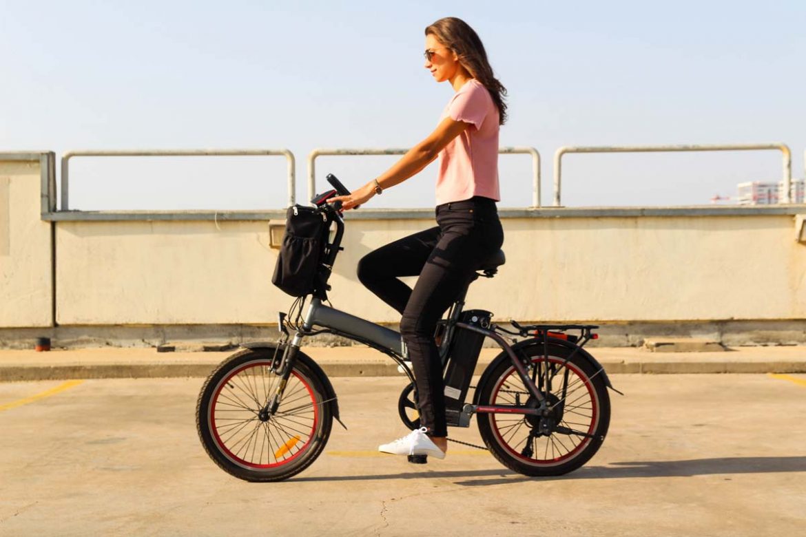 A,Young,Woman,Riding,An,Electric,Bicycle